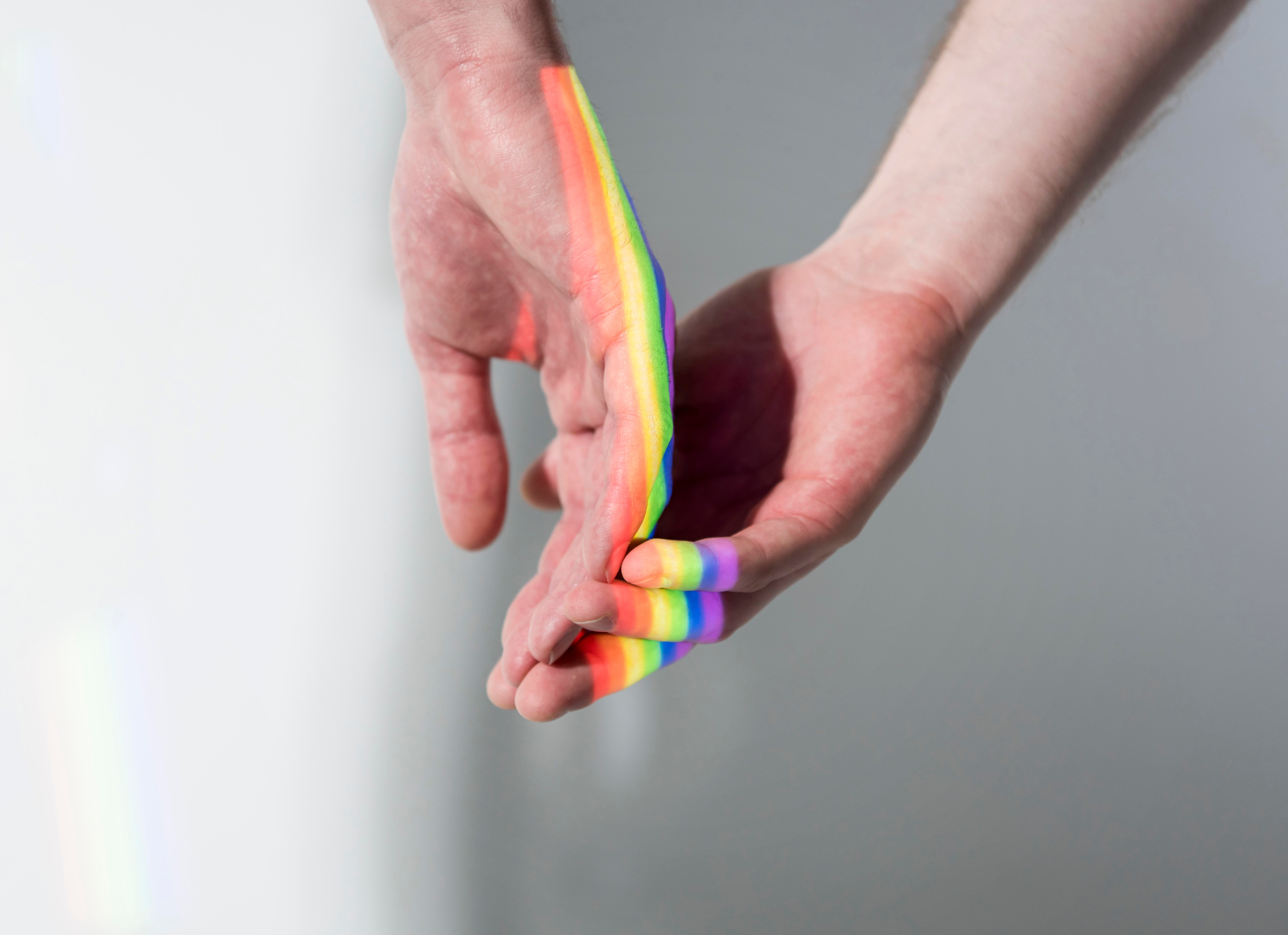 men-loving-each-other-with-lgbt-symbol